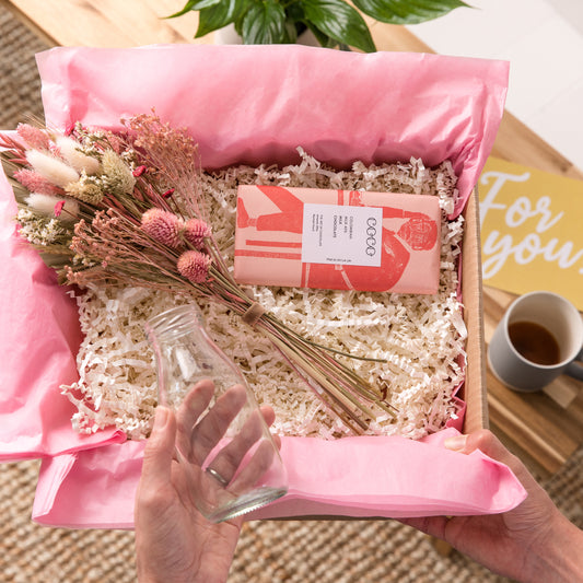 Happy Letterbox Gift Co. | Dried flower posie with glass bottle in Muted Pinks. Our gorgeous dried flower gift boxes come with a glass milk bottle vase and delicious artisan chocolate - all wrapped in pink tissue paper with a gift card that we can add a hand written message to.